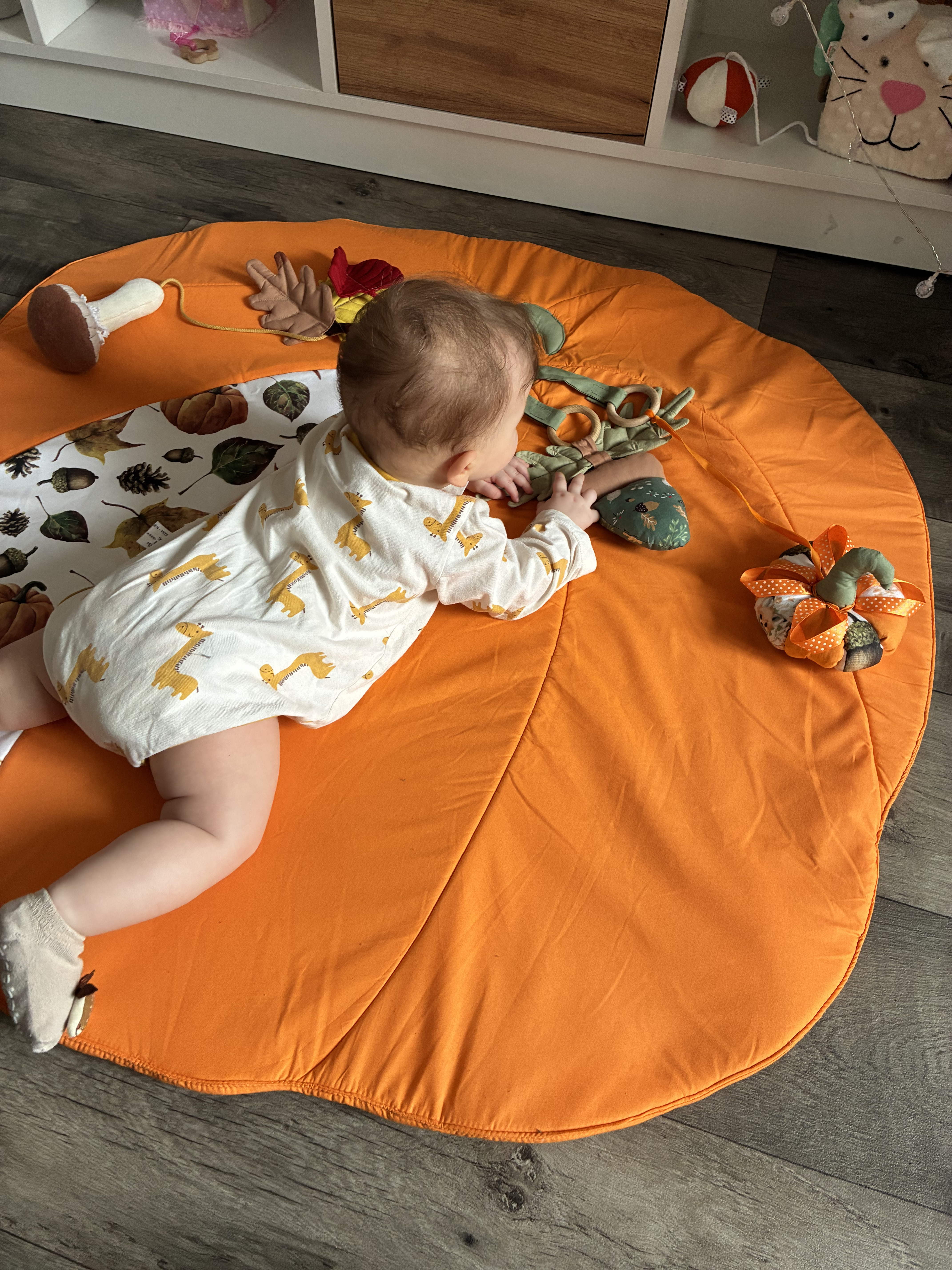 Baby exploring sensory elements on play mat